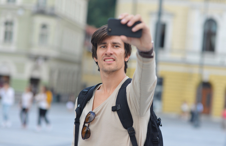 Student / tourist taking funny self portrait in the europe streetの写真素材