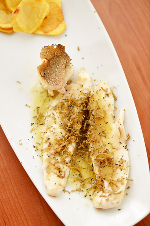 Black Truffle Sea Bass with potatoesの写真素材
