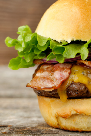 Gourmet bacon cheeseburger with lettuce and tomatoの写真素材