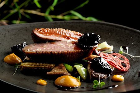 Haute cuisine/Asian fusion, roasted duck with plums and shiitake mushroomsの写真素材