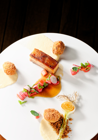 Plated freshly grilled pork bellies with rhubarb vegetableの写真素材