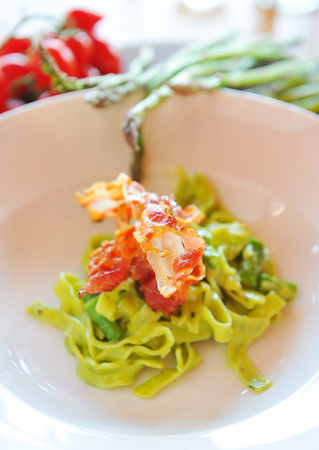 Italian pasta with bacon and asparagusの写真素材
