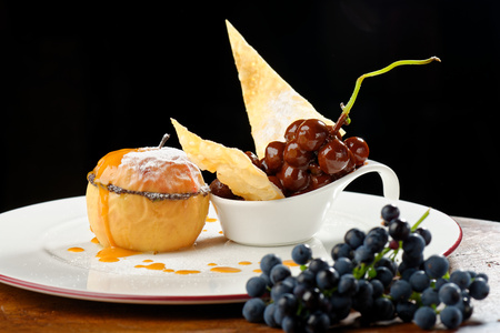 Baked apple and grape in chocolateの写真素材