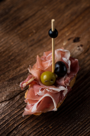Tapas on Crusty Bread - Selection of Spanish tapas served on a sliced baguette.の写真素材