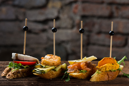 Tapas on Crusty Bread - Selection of Spanish tapas served on a sliced baguette.の写真素材
