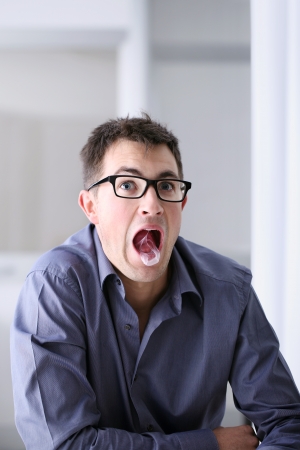 Man in home office with chewing gum の写真素材