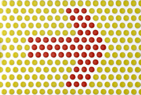 arrow symbol on the tile with round red and yellowの写真素材