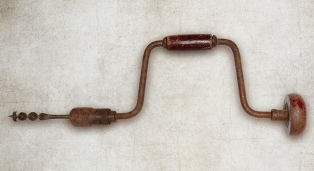 Old hand drill carpenter tool isolatedの写真素材