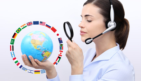 concept search, customer service operator woman with headset, globe, flags,  magnifying glassの写真素材
