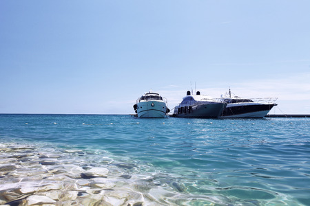 luxury boats on the beach, in blue sea and blue skyの写真素材