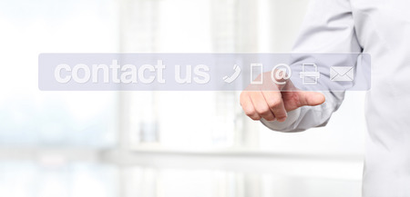 hand touch screen display with contact us concept text and icons