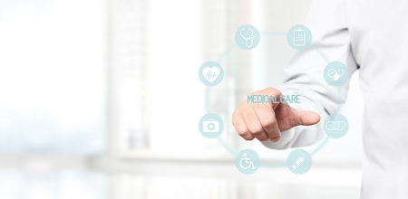 Doctor hand touching medical icons on virtual screen, medicine conceptの写真素材