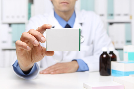 Doctor hand showing drug boxes at Office Desktop. Health care, Medical and Pharmacy Conceptの写真素材