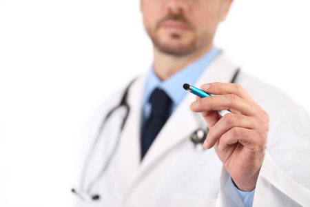 Doctor hand with a pen pointing on white, prescription conceptの写真素材