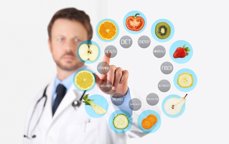 healthy food concept, Hand of nutritionist doctor pointing fruits with finger.の写真素材