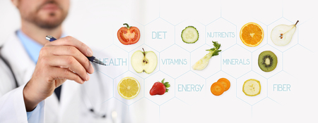 healthy food concept, Hand of nutritionist doctor pointing fruits with pen.の写真素材