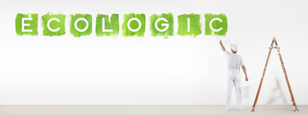 painter man painting green color ecologic text isolated on blank white wall background, banner web.の写真素材
