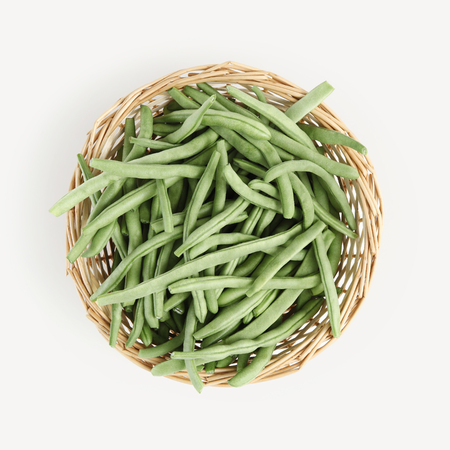 top view wicker basket of green beans isolated on white background.の写真素材