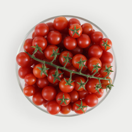 top view cherry tomatoes in glass bowl isolated on white background.の写真素材