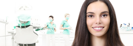 dental care concept, beautiful smiling woman on dentist clinic background with dentist's chair, web banner template.の写真素材