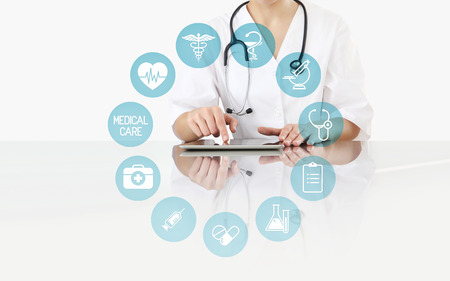 doctor at desk with digital tablet, healthcare and medical icons, isolated on white.