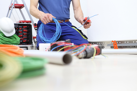 electrician at work with nippers in hand,の写真素材