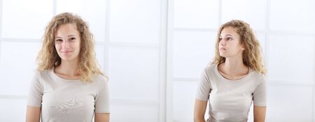 portrait of young casual woman with curly and long red hair isolated on white window background.の写真素材