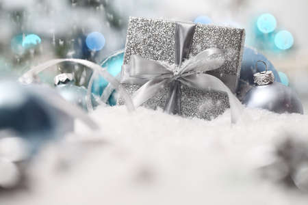 merry christmas background, silver gift present box with bow and ribbon, next to blue Christmas...