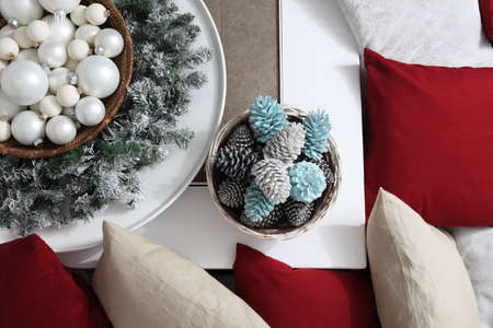 top view christmas decorations centerpiece with garland and balls near a basket with colorful pine...