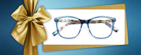 glasses christmas gift card, shiny golden ribbon bow isolated on glittering turquoise background, ticket and blue eyewear isolated on white, template for promotional and shopping banner or labelの写真素材