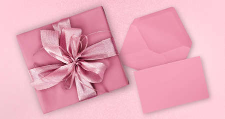 Mothers day gift card, pink box with pink shiny ribbon bow, isolated on glittering background, blank...