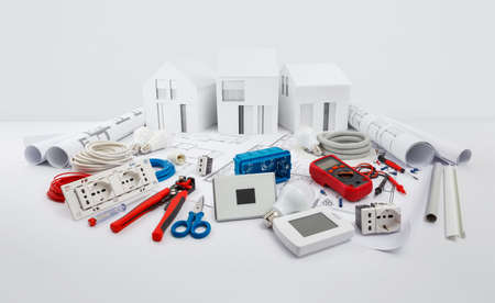 electrical controls for house planning, equipment and electrician work tools on blueprint with model...