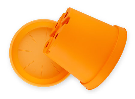 Gardening orange plastic pot with plate, top view isolated on white background with clipping path. Banner for sale of plants and flowers productsの写真素材