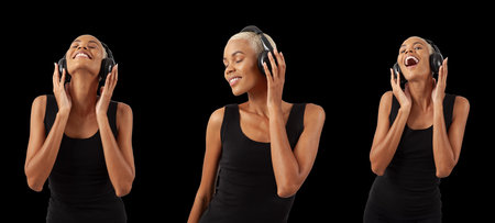 Smiling African woman wears black headphones and listening music playlist or podcast, figure relaxing and dancing isolated on black background.の写真素材