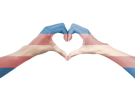 Closeup of women couple's painted hands with the transgender flag forming a heart shape. Symbol of LGBTQ pride, love, diversity, inclusion, equality, and human rights. Isolated on white backgroundの写真素材