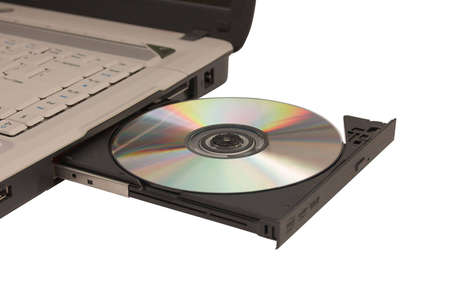  open laptop cd drive with cdrom in it isolated over whiteの写真素材