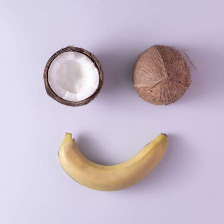 Sliced ââcoconut and banana on a gray background. Minimal style. Flat layの写真素材