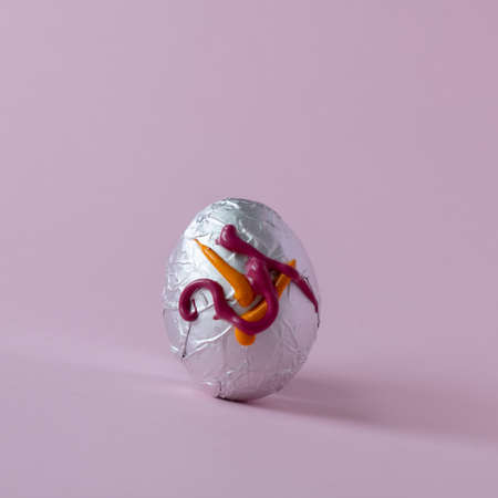 Easter egg on a pastel pink background painted in tempera colors. Minimal concept of Easter holidaysの写真素材