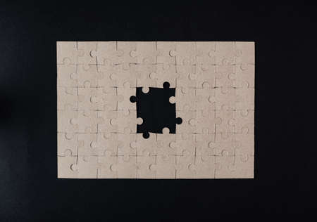 Cardboard puzzles on a black background.Flat lay. Copy spaceの写真素材