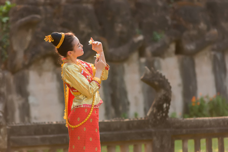 Beautiful girl in Laos costume,Asian woman wearing traditional Laos culture at temple.Vintage style.