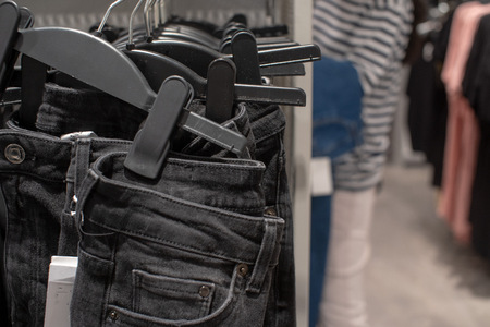 Jeans put on sale in shop, The seller in a clothing store.の写真素材