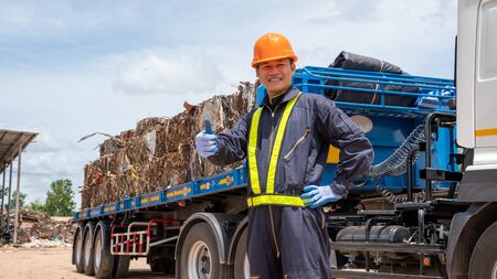 Foreman with safety hats and safety vest is carrying a car inspection document in the parking with...