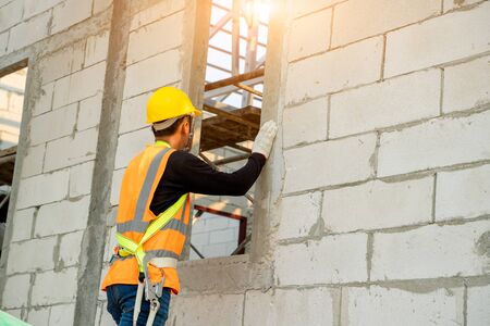 Engineer Industrial working for building exterior walls with Lightweight Concrete and mortar.