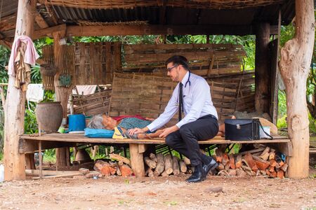 Doctor measured the pressure of the elderly,Senior woman patient and doctor with tonometer measuring blood pressure at Remote Areas,Coronavirus Disease 2019 (COVID-19).の写真素材