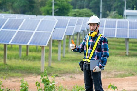 Electricity solar power engineering,Engineer checking solar panel in routine operation at solar...