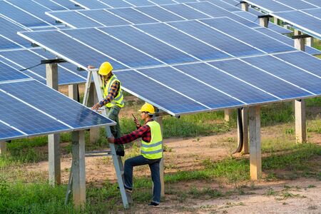 Engineer and technician discussion plan to find problem of solar panel,Engineer working on checking...