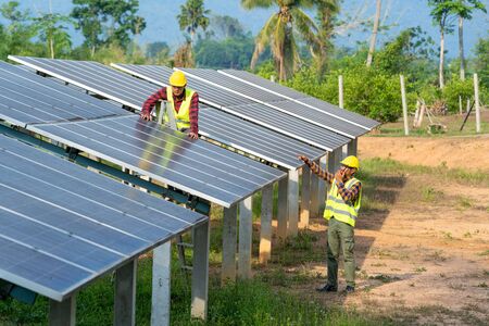 Group of engineer checking solar panel in routine operation at solar power plant,Operation and...