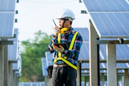 Solar power plant,Engineer working on checking and maintenance in solar power plant on a background of photovoltaic panels,Science solar energy.の写真素材