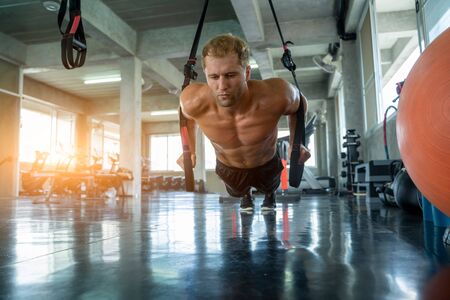 Sportsman exercising with battle ropes during strength workout in gym,Sport,Fitness and healthy life...