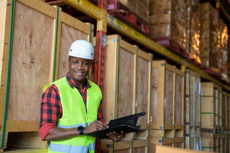 Portrait warehouse workers holding a clipboard working in a warehouse.の写真素材